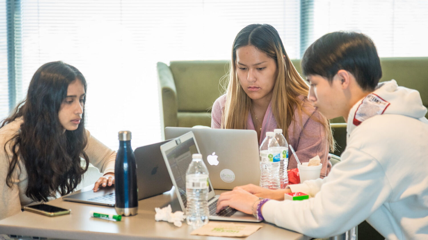 Three students working on a project together.