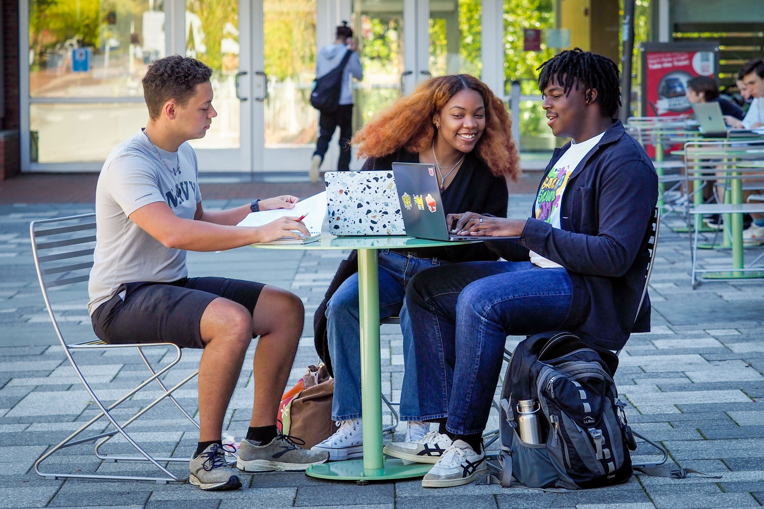 Students enjoy a fall day while working on a project outside SAS Hall. Photo by Becky Kirkland.