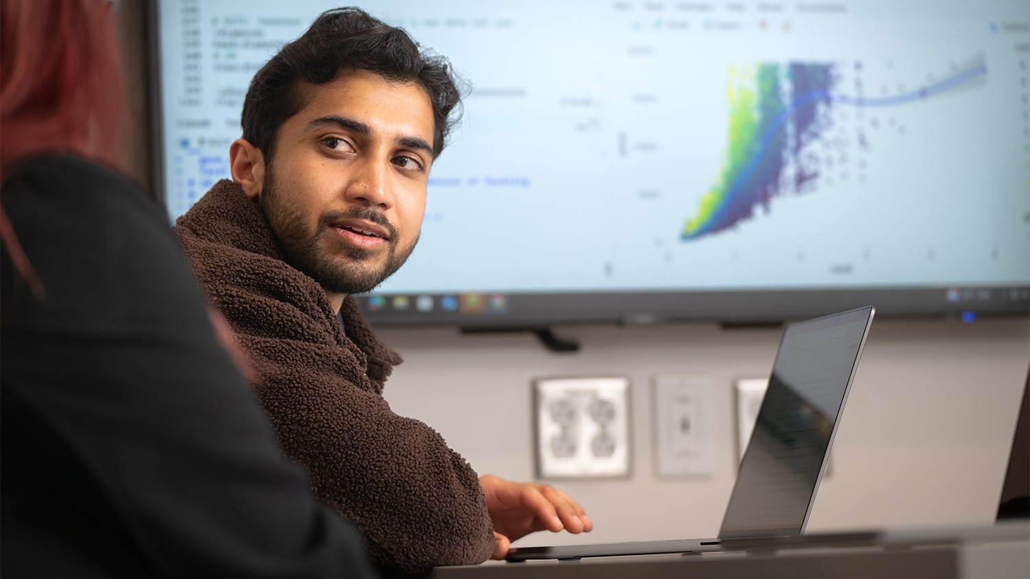 Research data consultant Abhinandra (Abhi) Singh works with a colleague.
