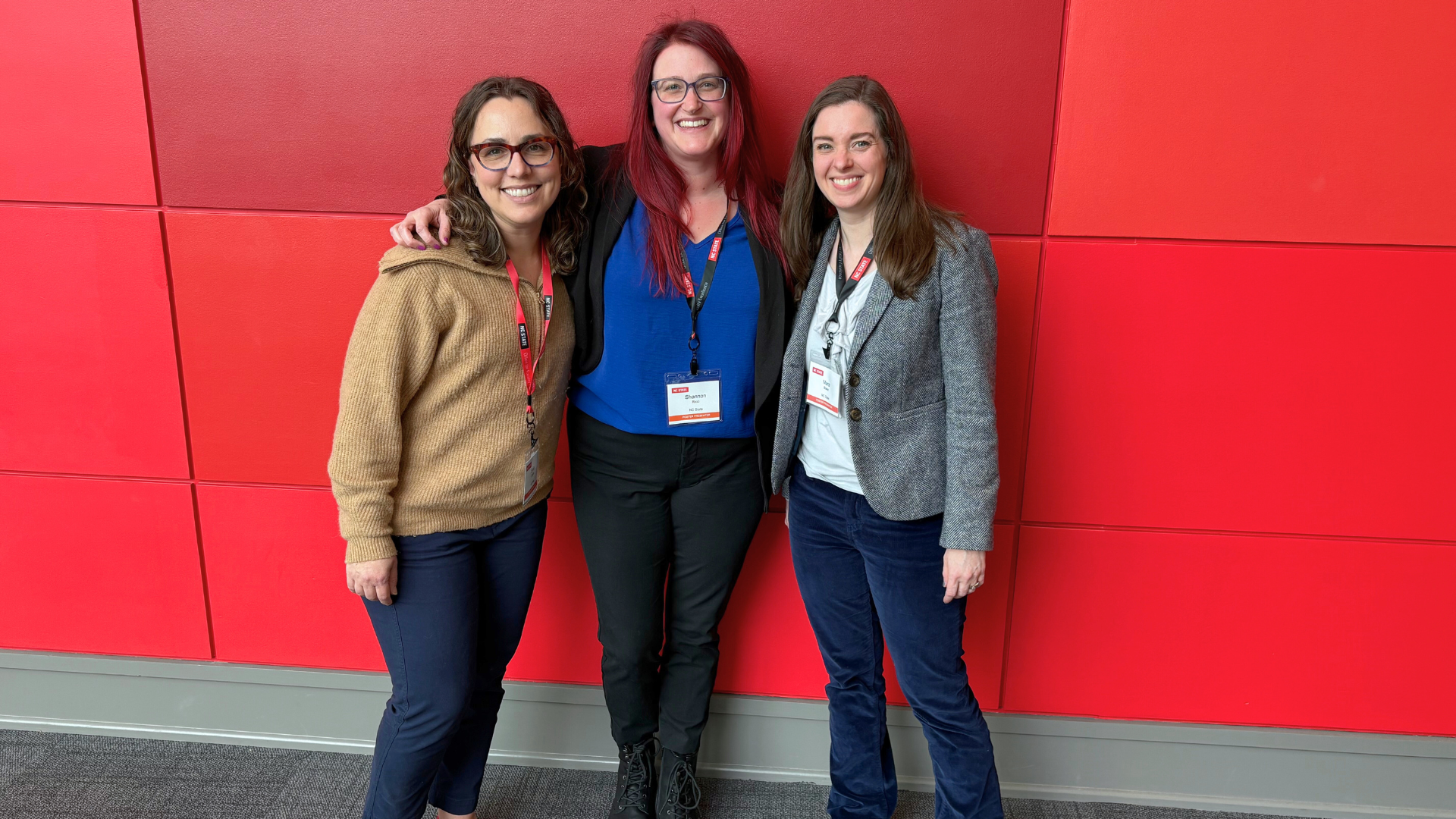 Alt text/caption: NC State’s Emily Griffith, Shannon Ricci, and Mara Blake (left to right) give a poster presentation at the 2025 NC State Conference on Faculty Excellence.